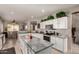 Bright kitchen with granite countertops, white cabinets, stainless appliances, and an island at 26272 N 73Rd Dr, Peoria, AZ 85383