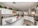 Bright kitchen with granite counters, white cabinetry, stainless appliances and central island at 26272 N 73Rd Dr, Peoria, AZ 85383