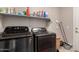 This laundry room has modern appliances and shelving for storage at 26272 N 73Rd Dr, Peoria, AZ 85383
