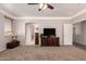 Large main bedroom suite with neutral carpet, ceiling fan, and sitting area at 26272 N 73Rd Dr, Peoria, AZ 85383