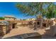 This outdoor kitchen features a barbecue grill and fireplace with brick pavers at 26272 N 73Rd Dr, Peoria, AZ 85383