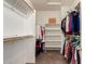 Spacious walk-in closet with ample storage space and wooden racks for organizing clothes and accessories at 26272 N 73Rd Dr, Peoria, AZ 85383