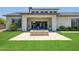 Backyard with a stone fire pit, covered patio with comfortable seating, and manicured landscaping at 2630 E Lovebird Ln, Gilbert, AZ 85297