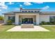 Beautiful backyard with a stone fire pit, covered patio, and lush green lawn, ideal for entertaining or relaxing at 2630 E Lovebird Ln, Gilbert, AZ 85297