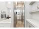 Modern bathroom with glass shower, floating shelves, soaking tub, vanity, and wood-look floors at 2630 E Lovebird Ln, Gilbert, AZ 85297
