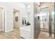 Modern bathroom with a glass shower, a soaking tub, and a vanity area, all with wood-look floors at 2630 E Lovebird Ln, Gilbert, AZ 85297