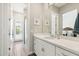Bright bathroom featuring a vanity with quartz countertop, a mirror, and a walk-in shower at 2630 E Lovebird Ln, Gilbert, AZ 85297