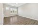 Bright bedroom featuring wood floors, plantation shutters, and ample natural light at 2630 E Lovebird Ln, Gilbert, AZ 85297