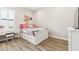 White bedroom with light colored floors, window, and flower themed decor at 2630 E Lovebird Ln, Gilbert, AZ 85297