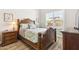 Cozy bedroom featuring a wooden bed frame, neutral walls, and wood-style flooring at 2630 E Lovebird Ln, Gilbert, AZ 85297