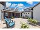 Charming courtyard with string lights, fountain, blue chairs, and lush white flowering landscaping at 2630 E Lovebird Ln, Gilbert, AZ 85297