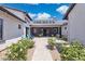 Charming courtyard with string lights, fountain, blue chairs, and lush white flowering landscaping at 2630 E Lovebird Ln, Gilbert, AZ 85297