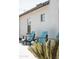 Blue Adirondack chairs sit in front of a textured stucco wall in the home's courtyard at 2630 E Lovebird Ln, Gilbert, AZ 85297