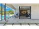 Elegant covered patio with an open floor plan, connecting to an in-ground pool and a modern kitchen at 2630 E Lovebird Ln, Gilbert, AZ 85297