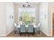 Dining area with lots of light, seating for six, and wood-look tile flooring at 2630 E Lovebird Ln, Gilbert, AZ 85297