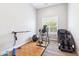 The exercise room has wood floors, a window, and an exercise machine at 2630 E Lovebird Ln, Gilbert, AZ 85297