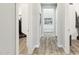 Hallway leading to the closet and bathroom, with consistent wood-look flooring throughout the home at 2630 E Lovebird Ln, Gilbert, AZ 85297