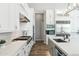 Modern kitchen design with white cabinets, stainless steel appliances, and wood-look tile flooring at 2630 E Lovebird Ln, Gilbert, AZ 85297