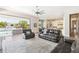 Bright living room featuring leather furniture, wood floors, an open sliding door and a view of the pool at 2630 E Lovebird Ln, Gilbert, AZ 85297