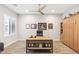 Home office with wood floors, a ceiling fan, and a built-in bookshelf at 2630 E Lovebird Ln, Gilbert, AZ 85297