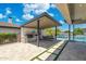 Outdoor kitchen with built in grill and outdoor dining, adjacent to refreshing pool at 2630 E Lovebird Ln, Gilbert, AZ 85297