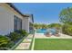 Inviting backyard oasis featuring a sparkling pool, spa, and travertine deck with lounge chairs for relaxation at 2630 E Lovebird Ln, Gilbert, AZ 85297