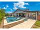 A luxurious backyard featuring a pool, spa, and covered patio at 2630 E Lovebird Ln, Gilbert, AZ 85297