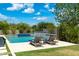 Relaxing pool area with lounge chairs and water features, surrounded by greenery for added privacy at 2630 E Lovebird Ln, Gilbert, AZ 85297