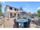 Exterior view of home featuring a backyard with fenced pool, patio, seating, and desert landscaping at 27053 N 172Nd Ln, Surprise, AZ 85387
