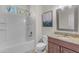 Clean bathroom featuring a shower-tub combo, single sink vanity, and neutral decor, providing a functional and tidy space at 27053 N 172Nd Ln, Surprise, AZ 85387