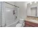 Clean bathroom with a shower-tub combo, granite countertop, and tiled walls at 27053 N 172Nd Ln, Surprise, AZ 85387