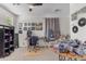 Spacious bedroom with ceiling fan, carpeted floor, and abundant natural light from the large windows at 27053 N 172Nd Ln, Surprise, AZ 85387