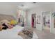 Bright bedroom featuring neutral walls, carpet, ceiling fan, and a closet for storage at 27053 N 172Nd Ln, Surprise, AZ 85387