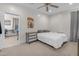 Cozy bedroom with a ceiling fan, carpeted floor, and an adjacent room that could be an office at 27053 N 172Nd Ln, Surprise, AZ 85387