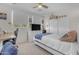 Bright bedroom featuring a ceiling fan, modern furniture, and a window with natural light at 27053 N 172Nd Ln, Surprise, AZ 85387