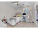 Cozy bedroom featuring neutral walls, carpet, ceiling fan, and a large window with natural light at 27053 N 172Nd Ln, Surprise, AZ 85387