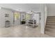 Open concept dining area with tile floors, large windows, and a built in hutch near the staircase at 27053 N 172Nd Ln, Surprise, AZ 85387