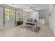 Bright dining room with a wooden table, chairs, bench, and built-in white cabinets for stylish storage and decor at 27053 N 172Nd Ln, Surprise, AZ 85387
