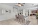 Bright dining room with a wooden table, chairs, bench, and adjacent kitchen and stairs at 27053 N 172Nd Ln, Surprise, AZ 85387