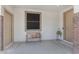 Welcoming entryway with a bench and decorative pillows between two front doors, creating a cozy and inviting space at 27053 N 172Nd Ln, Surprise, AZ 85387