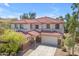 Inviting two-story home with tile roof and brick accents, offering a warm welcome at 27053 N 172Nd Ln, Surprise, AZ 85387