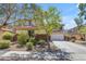 Lovely home with a two-car garage, well-maintained landscaping, and beautiful trees in the front yard at 27053 N 172Nd Ln, Surprise, AZ 85387