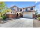 Charming two-story home boasts a brick and stucco exterior with a spacious two car garage and well maintained landscaping at 27053 N 172Nd Ln, Surprise, AZ 85387