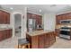 Well-equipped kitchen featuring stainless steel appliances, granite countertops, a kitchen island, and ample cabinetry at 27053 N 172Nd Ln, Surprise, AZ 85387