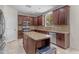 Well-equipped kitchen featuring stainless steel appliances, granite countertops, a kitchen island, and ample cabinetry at 27053 N 172Nd Ln, Surprise, AZ 85387