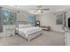 Spacious main bedroom featuring neutral paint, carpet, ceiling fan, and large windows at 27053 N 172Nd Ln, Surprise, AZ 85387