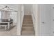 Staircase with carpet leading to the upper level and views of the dining area at 27053 N 172Nd Ln, Surprise, AZ 85387