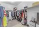 Walk-in closet with extensive shelving and hanging space, designed for optimal storage and organization at 27053 N 172Nd Ln, Surprise, AZ 85387