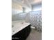 Bathroom with double vanity, white countertops, and shower-tub combo with decorative shower curtain at 29906 W Whitton Ave, Buckeye, AZ 85396
