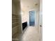 Bright bathroom with well-lit vanity, open shelving, and a view of an adjacent room at 29906 W Whitton Ave, Buckeye, AZ 85396